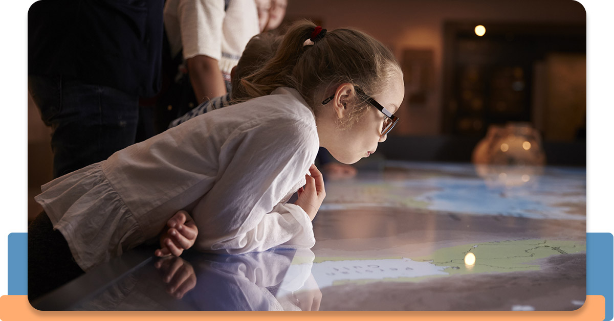 Young girl looking at a map at the children’s museum.