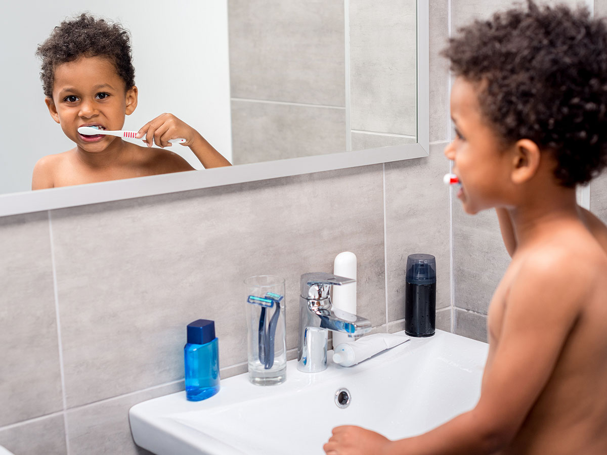 Little kid brushing his teeth