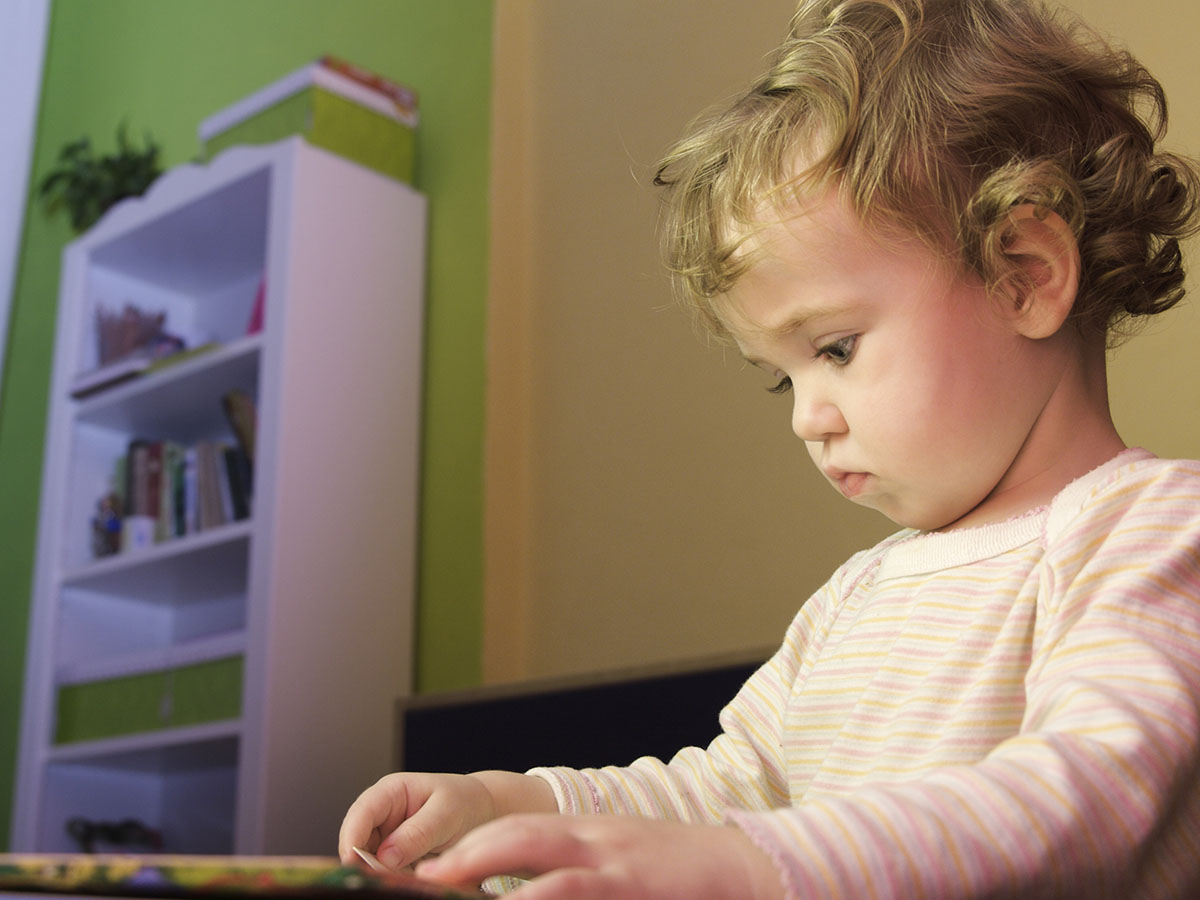 Little girl choosing which picture card