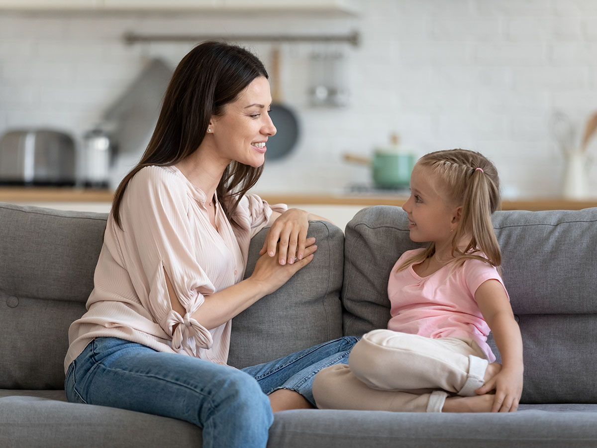 Mom talking on the couch with daughter