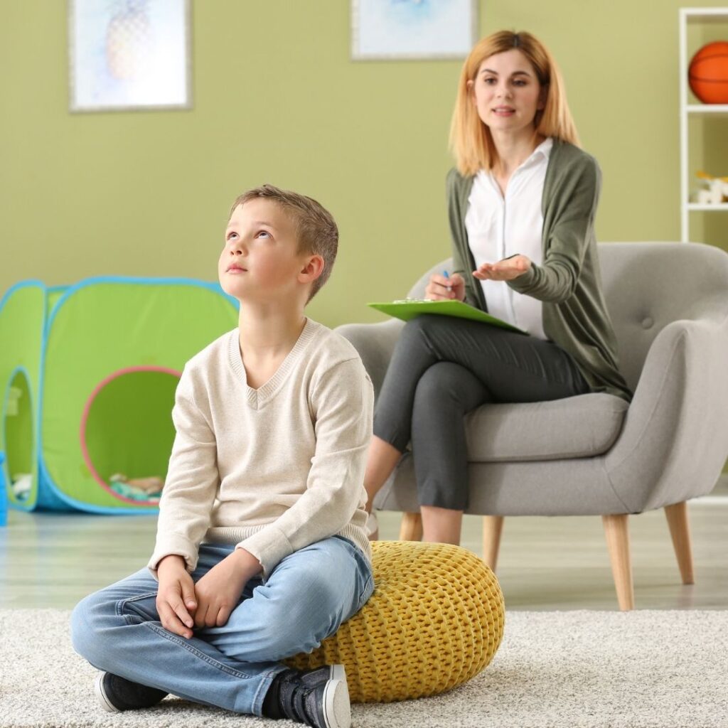 An autistic child rolling his eyes at his mother or teacher.