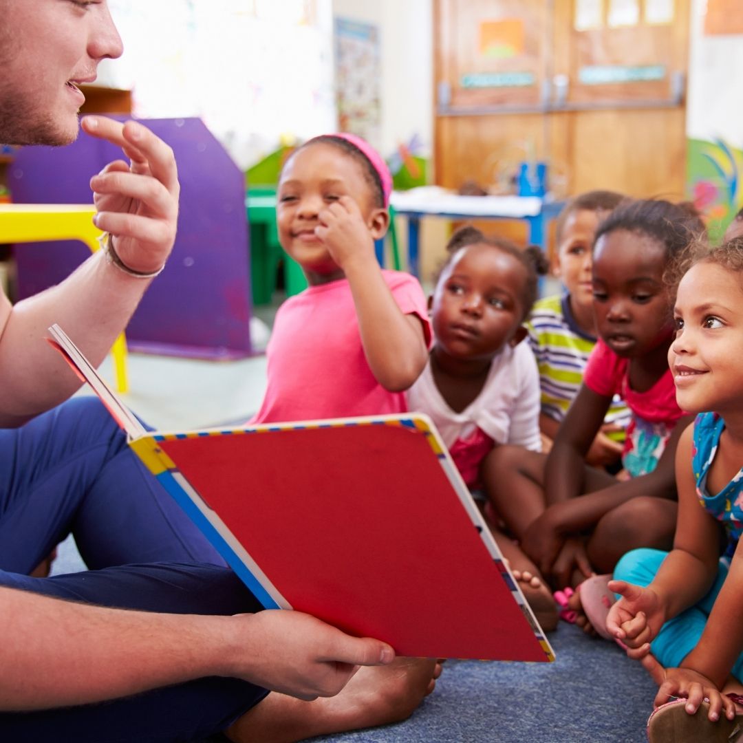teacher teaching class of small children