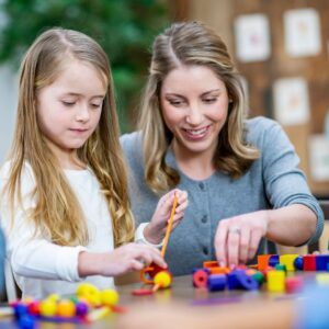teacher with child and toys