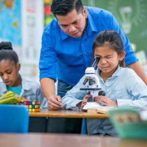 teacher with child and microscope