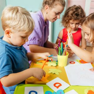 teacher and children working on crafts