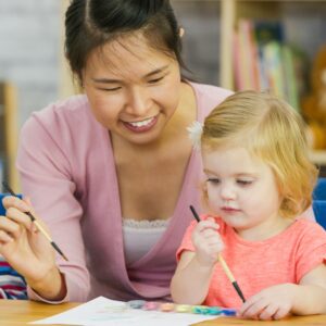 smiling teacher with child