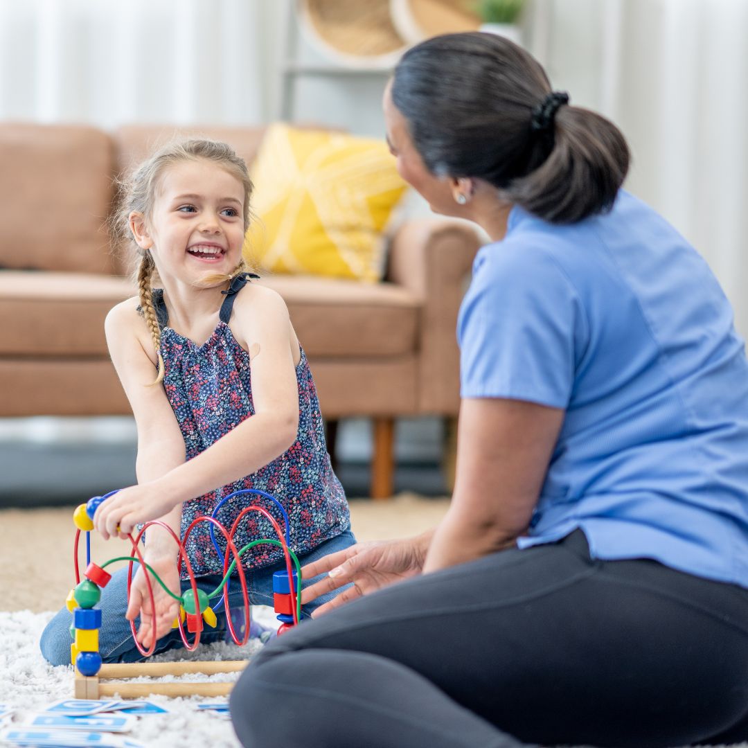 girl playing with therapist