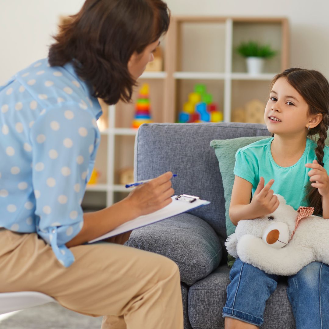 Therapist and child talking on couches