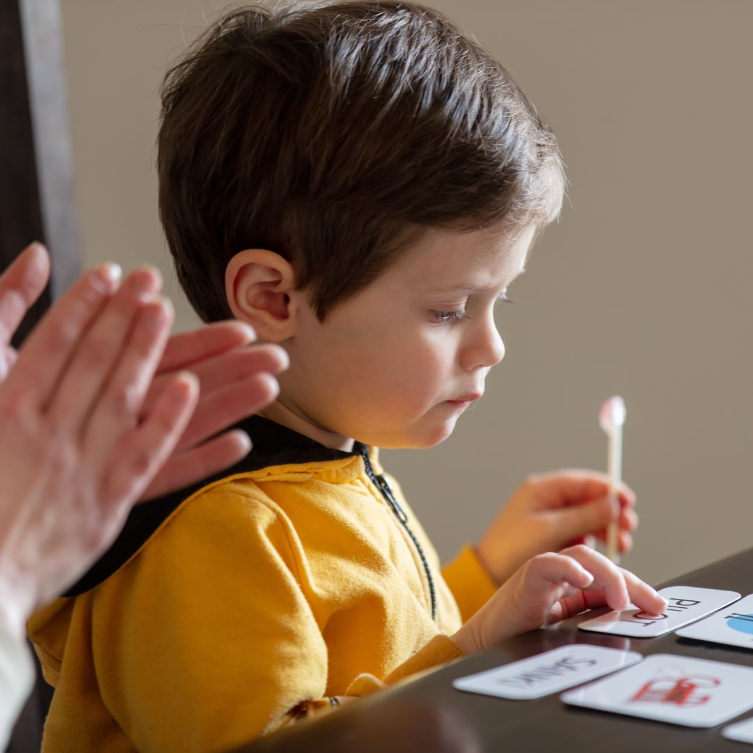 Child in ABA therapy studying cards