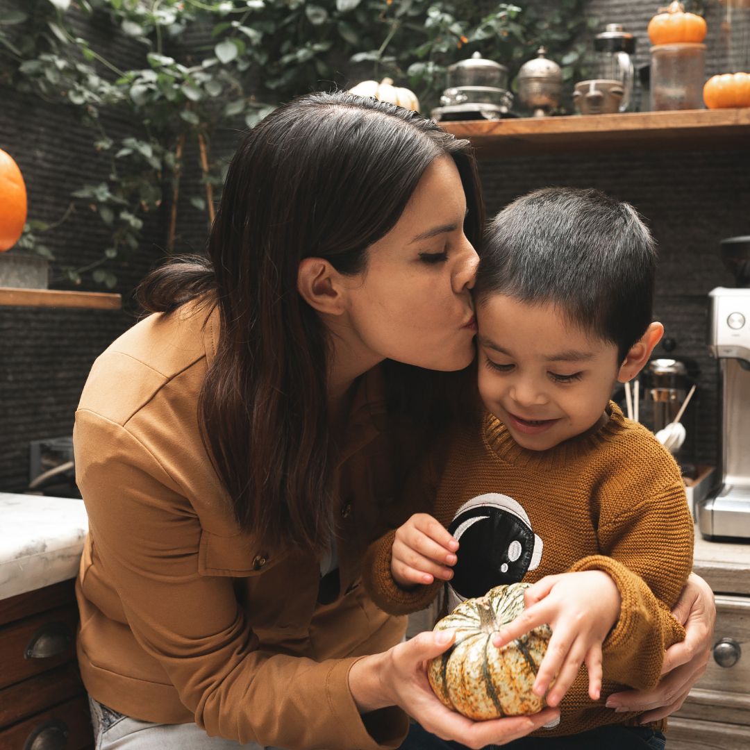 mom kissing her Autistic child
