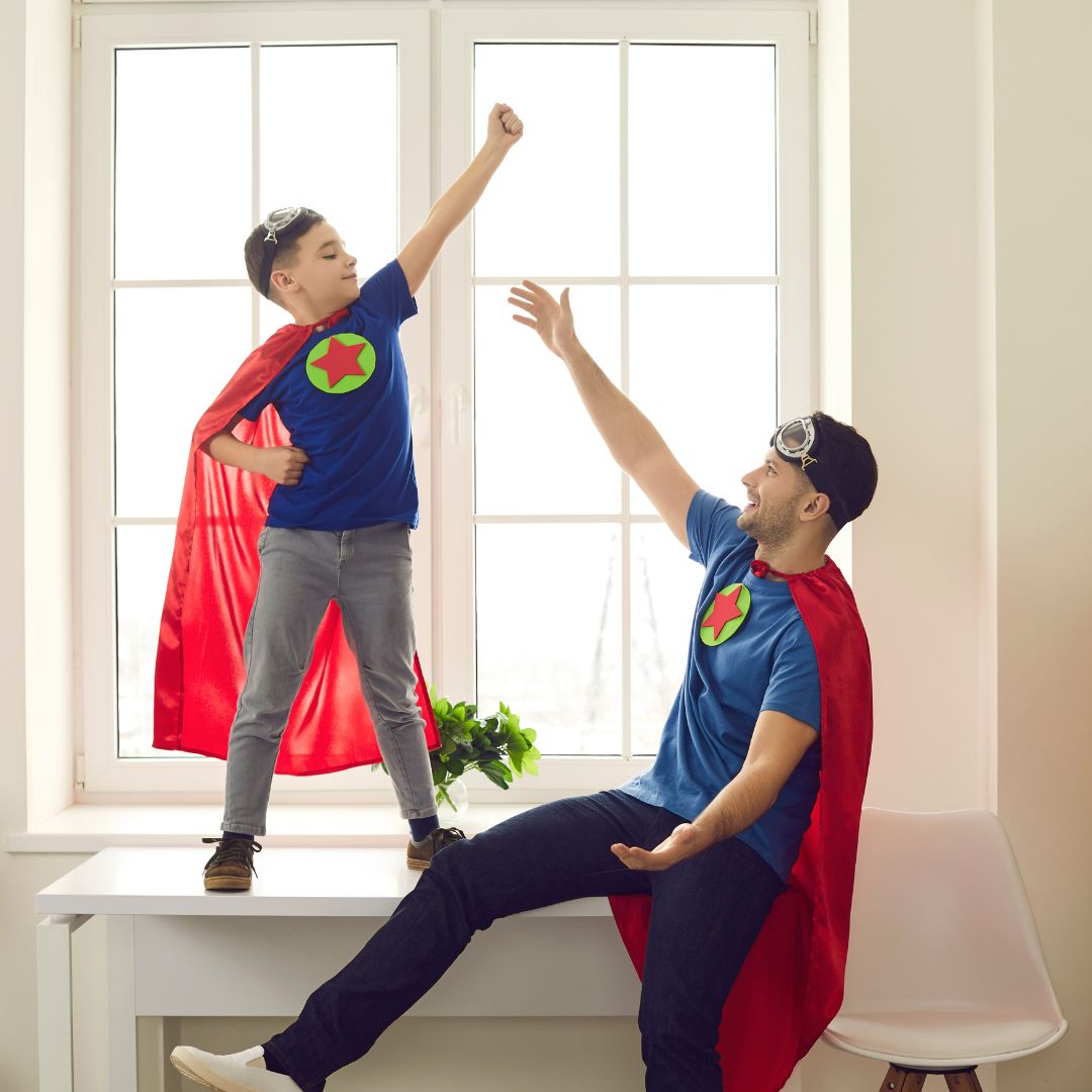 Father and son playing superheroes