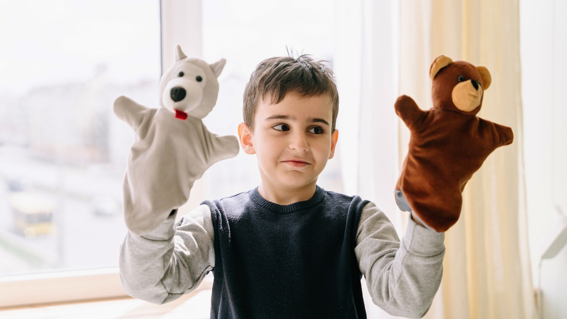 child playing with puppets