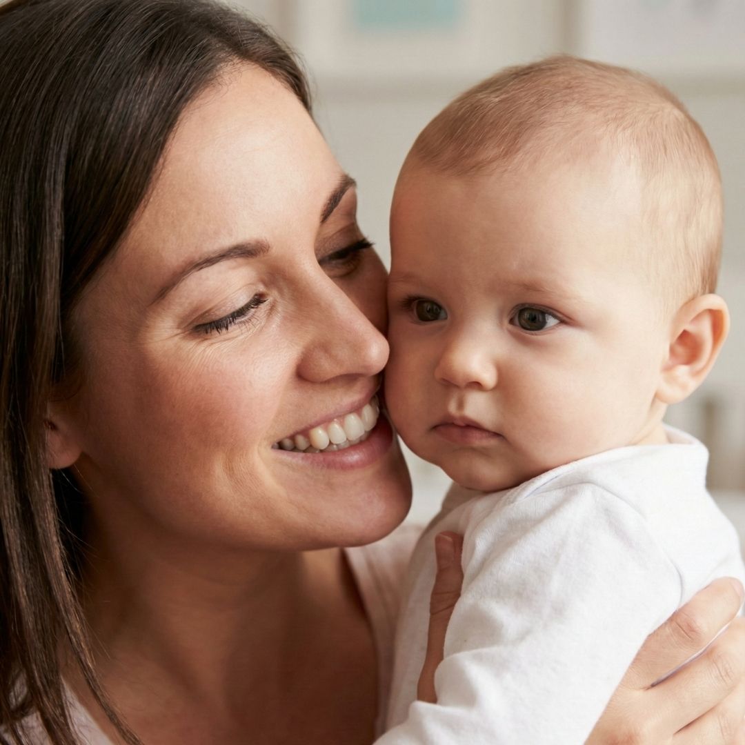 A close-up of a baby not returning a social smile to their mother.