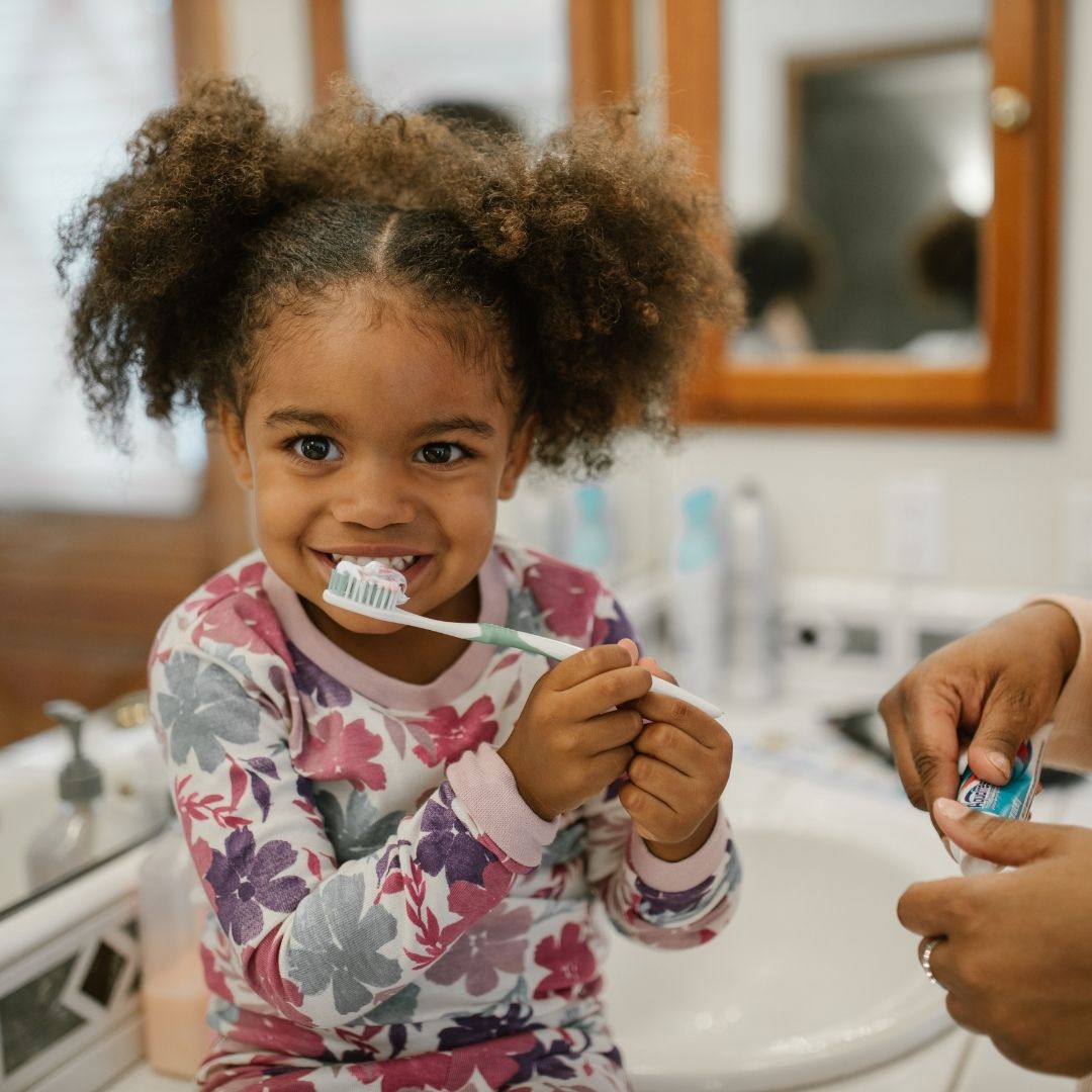 child brushing teeth