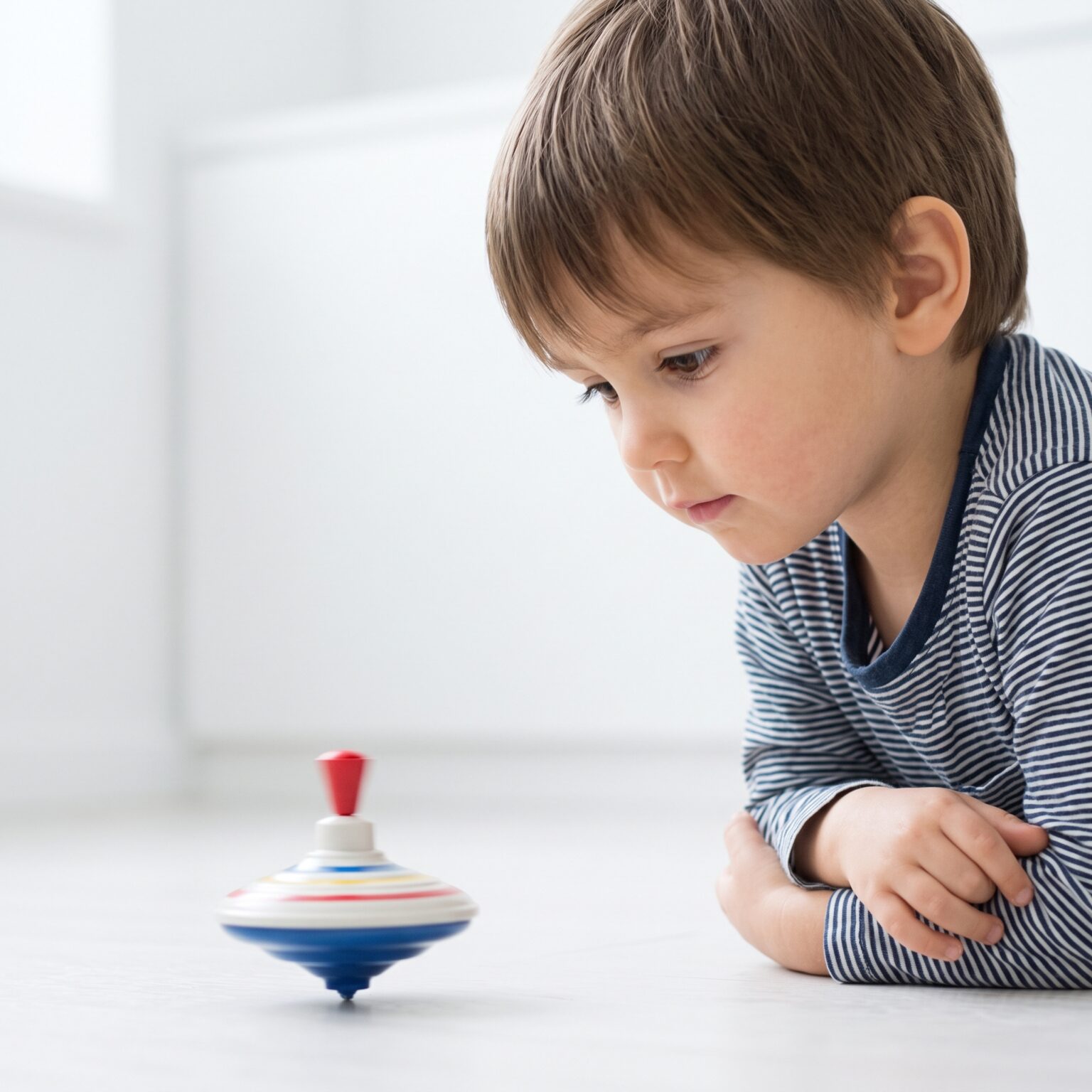 A child intently observing a spinning toy.